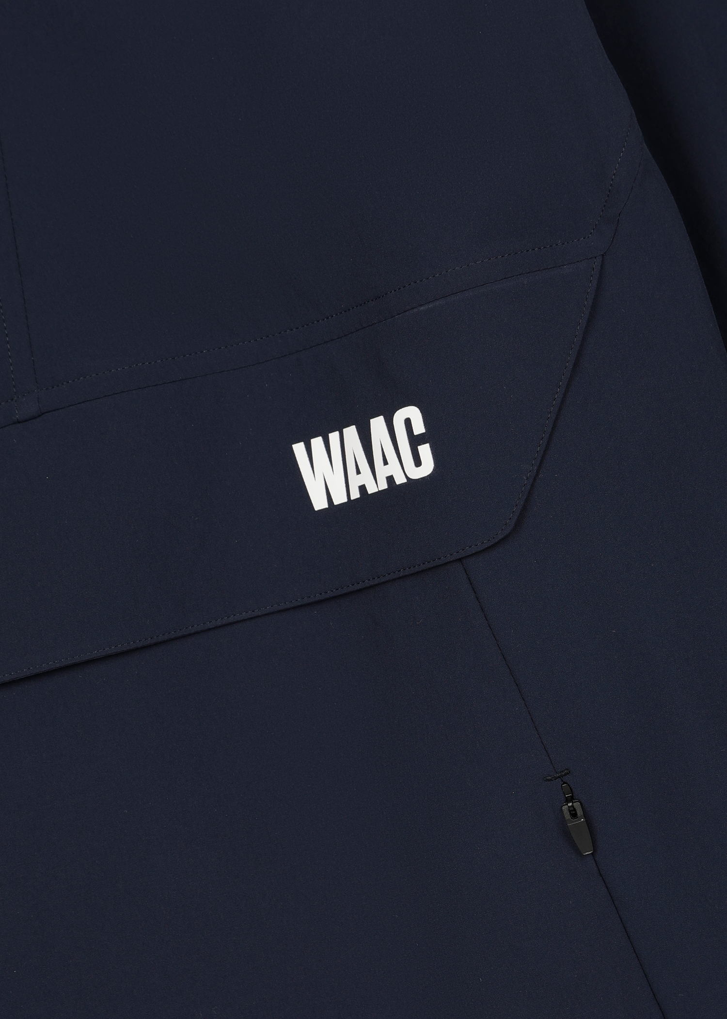 Lightweight anorak for active movement
Structured hood with a clean half zip
Back WAAC slogan panel detail